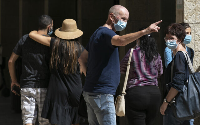 Jerusalem residents wearing face masks for fear of coronavirus walk and shop at the Mamilla Mall near Jerusalem's Old City on June 24, 2020. (Olivier Fitoussi/Flash90) Jerusalem residents wearing face masks for fear of coronavirus walk and shop at the Mamilla Mall near Jerusalem's Old City on June 24, 2020. (Olivier Fitoussi/Flash90)