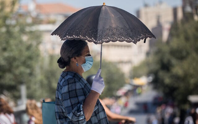 People walk with face masks on Jaffa Street in downtown Jerusalem on June 24, 2020. (Yonatan Sindel/Flash90) People walk with face masks on Jaffa Street in downtown Jerusalem on June 24, 2020. (Yonatan Sindel/Flash90)