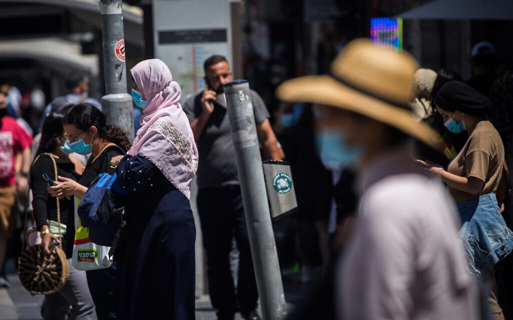 People walk with face masks on Jaffa Street in downtown Jerusalem on June 25, 2020. (Yonatan Sindel/Flash90)