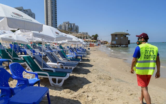 Bat Yam Municipality Inspector patrol at the beach in the Israeli coastal town of Bat Yam, near Tel Aviv, after it was closed following the spread of the coronavirus, June 26, 2020. (Flash90) Bat Yam Municipality Inspector patrol at the beach in the Israeli coastal town of Bat Yam, near Tel Aviv, after it was closed following the spread of the coronavirus, June 26, 2020. (Flash90)