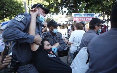 Police remove a protester during a protest against Prime Minister Benjamin Netanyahu outside the Prime Minister's Residence in Jerusalem, June 26, 2020. (Yonatan Sindel/Flash90)