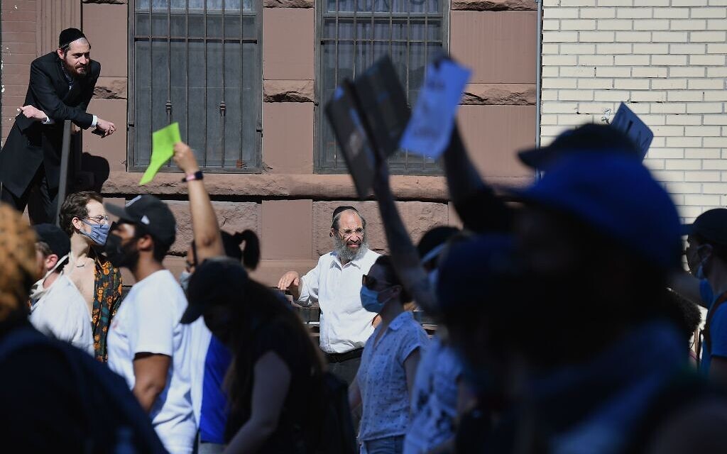 Illustrative: Members of the Orthodox Jewish community watch as protesters walk through the Brooklyn borough on June 3, 2020, during a 'Breonna Taylor and Black Lives Matter' protest in New York City, after the recent death in Minneapolis police custody of George Floyd. (Photo by Angela Weiss / AFP via Getty Images/ via JTA) Illustrative: Members of the Orthodox Jewish community watch as protesters walk through the Brooklyn borough on June 3, 2020, during a 'Breonna Taylor and Black Lives Matter' protest in New York City, after the recent death in Minneapolis police custody of George Floyd. (Photo by Angela Weiss / AFP via Getty Images/ via JTA)