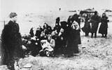 Members of a Latvian militia unit assemble a group of Jewish women for murder on a beach near Liepāja, December 15, 1941. (Bundesarchiv bild)