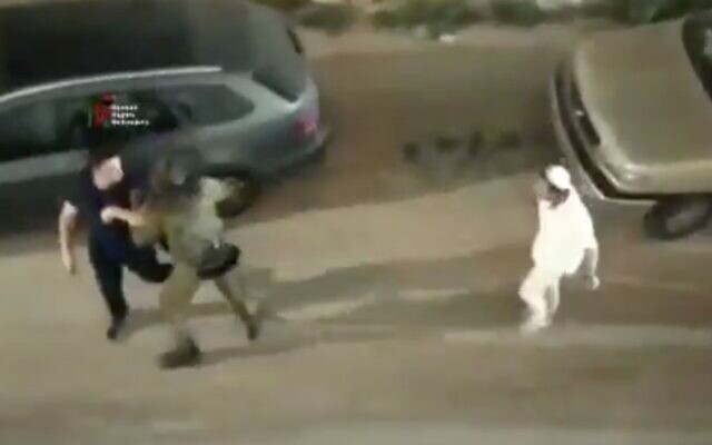 An IDF soldier (center) helps a Palestinian man (left) flee from a group of Israelis attacking him in the West Bank city of Hebron on June 13, 2020. (Screen capture: Twitter) An IDF soldier (center) helps a Palestinian man (left) flee from a group of Israelis attacking him in the West Bank city of Hebron on June 13, 2020. (Screen capture: Twitter)