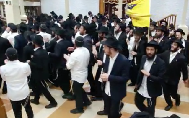 Worshipers dance at the Chabad synagogue at 770 Eastern Parkway in Brooklyn, June 22, 2020. (Screenshot from video via JTA) Worshipers dance at the Chabad synagogue at 770 Eastern Parkway in Brooklyn, June 22, 2020. (Screenshot from video via JTA)