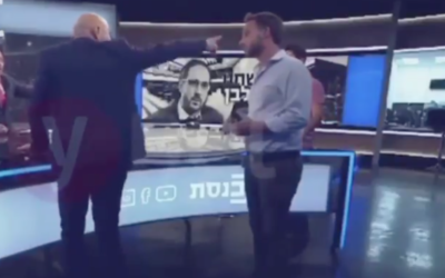 Screen capture from video of MK Ofer Shelah, Yesh Atid-Telem, left, with his back to the camera during an altercation while he was giving an interview to the Knesset Channel, May 2020. (Ynet)