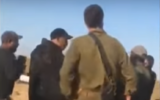 IDF officers confronted by a Bedouin crowd at the entrance to the town of Bir Hadaj in the Negev Desert, May 31, 2020. (Screenshot: YouTube)