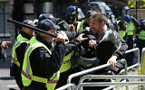 Police apprehend a protester in Whitehall near Parliament Square, London, during a protest by the Democratic Football Lads Alliance against a Black Lives Matter protest, June 13, 2020. (Jonathan Brady/PA via AP)