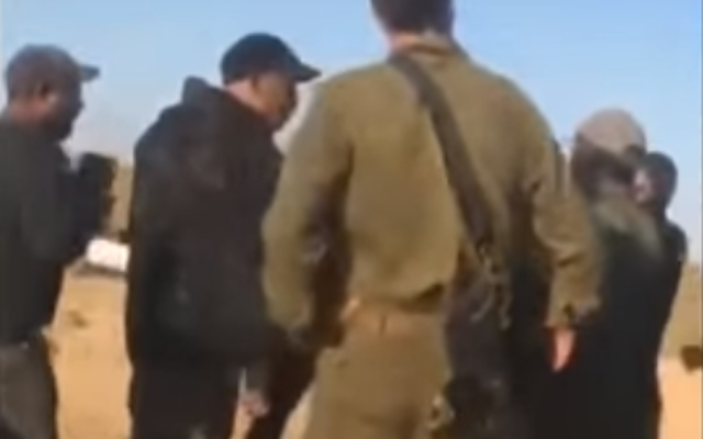 IDF officers confronted by a Bedouin crowd at the entrance to the town of Bir Hadaj in the Negev Desert, May 31, 2020. (Screenshot: YouTube) IDF officers confronted by a Bedouin crowd at the entrance to the town of Bir Hadaj in the Negev Desert, May 31, 2020. (Screenshot: YouTube)