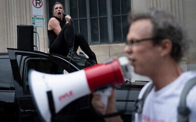 Demonstrators argue over loud speakers as people gather near an entrance point for a rally with US President Donald Trump in Tulsa, Oklahoma, June 19, 2020. (Brendan Smialowski/AFP)