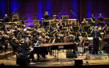 Israeli singer and composer Yoni Rechter performs with the Israeli Philharmonic Orchestra in Tel Aviv, February 7, 2018. (Yossi Zeliger/Flash90)