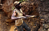 Illustrative: A miner digs out soil which will later be filtered for traces of cassiterite, the major ore of tin, at Nyabibwe mine, in eastern Congo, August 17, 2012. (AP/Marc Hofer)