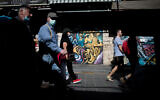 People walk past closed stores in the Mahane Yehuda market in Jerusalem, May 4, 2020. (Yonatan Sindel/Flash90)