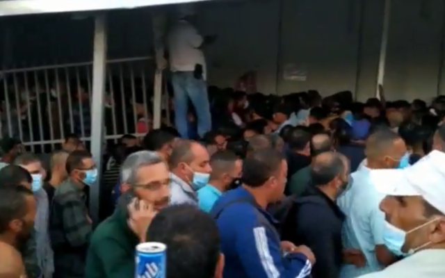 Palestinian workers on their way to work in Israel, at Bethlehem's Checkpoint 300 in the West Bank, June 2020. (Screenshot: Channel 12) Palestinian workers on their way to work in Israel, at Bethlehem's Checkpoint 300 in the West Bank, June 2020. (Screenshot: Channel 12)