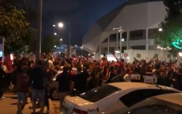 Hundreds of fans of soccer club Hapoel Tel Aviv celebrating a win outside Bloomfield Stadium in Tel Aviv on June 2, 2020, without adhering to social distancing rules. (Screenshot: Twitter) Hundreds of fans of soccer club Hapoel Tel Aviv celebrating a win outside Bloomfield Stadium in Tel Aviv on June 2, 2020, without adhering to social distancing rules. (Screenshot: Twitter)