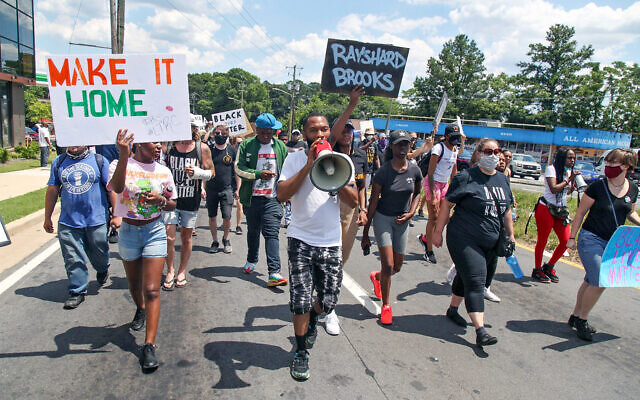 Protestors gather near a Wendy's restaurant where police killed a black man, Atlanta, Georgia, June 13, 2020. (Steve Schaefer/Atlanta Journal-Constitution via AP) Protestors gather near a Wendy's restaurant where police killed a black man, Atlanta, Georgia, June 13, 2020. (Steve Schaefer/Atlanta Journal-Constitution via AP)