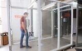 Dr. Izaak Cohen, a researcher at Bar-Ilan University, walking through the sanitation and disinfection tunnel developed by RD Pack which uses his technology; Bloomfield Stadium, Tel Aviv, June 2, 2020 (Yoni Reif)
