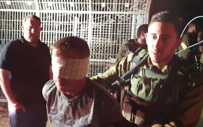 IDF soldiers detain a Palestinian caught trying to infiltrate Itamar settlement with a knife on June 9, 2020. (Roy Hadi/Samaria Regional Council)