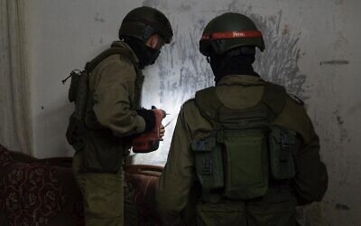 Israeli troops measure the home of a Palestinian man suspected of killing a soldier with a brick, in the West Bank village of Yabed on June 11, 2020. (Israel Defense Forces)
