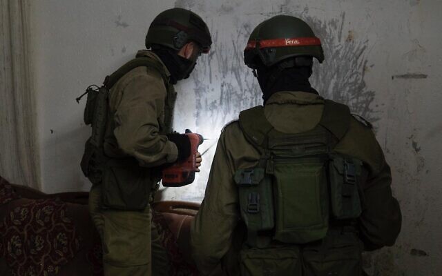 Israeli troops measure the home of a Palestinian man suspected of killing a soldier with a brick, in the West Bank village of Yabed on June 11, 2020. (Israel Defense Forces) Israeli troops measure the home of a Palestinian man suspected of killing a soldier with a brick, in the West Bank village of Yabed on June 11, 2020. (Israel Defense Forces)