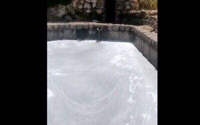 Hikers pour soap into the Lifta spring (screen capture: Channel 12)