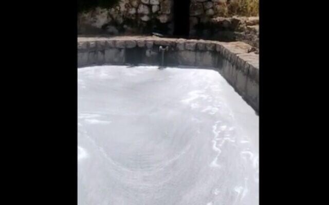 Hikers pour soap into the Lifta spring (screen capture: Channel 12)