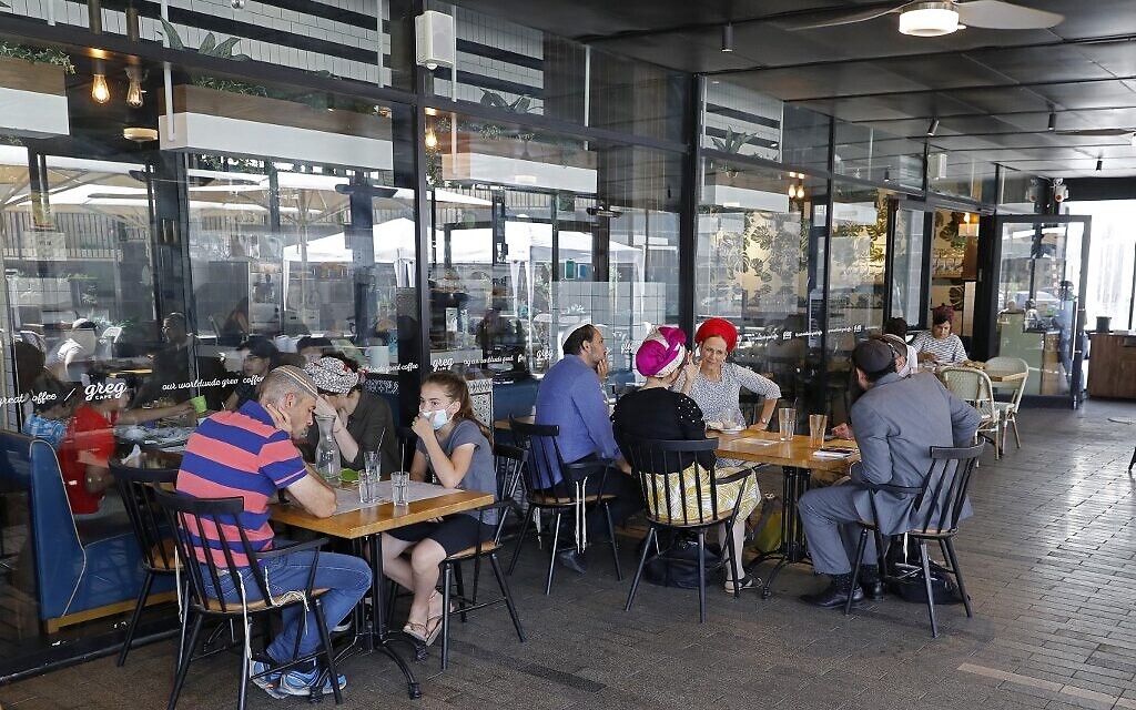 Israeli sit at a cafe in the West Bank settlement of Ariel, on July 1, 2020. (Jack Guez/AFP) Israeli sit at a cafe in the West Bank settlement of Ariel, on July 1, 2020. (Jack Guez/AFP)