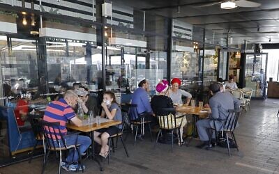 Israeli sit at a cafe in the West Bank settlement of Ariel, on July 1, 2020. (Jack Guez/AFP)