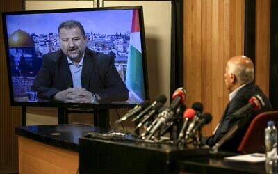 Senior Fatah official Jibril Rajoub, in the West Bank city of Ramallah, attends by video conference a meeting with deputy Hamas chief Saleh Arouri (on screen from Beirut) discussing Israel's plan to annex parts of the West Bank, on July 2, 2020. (Abbas Momani/AFP)
