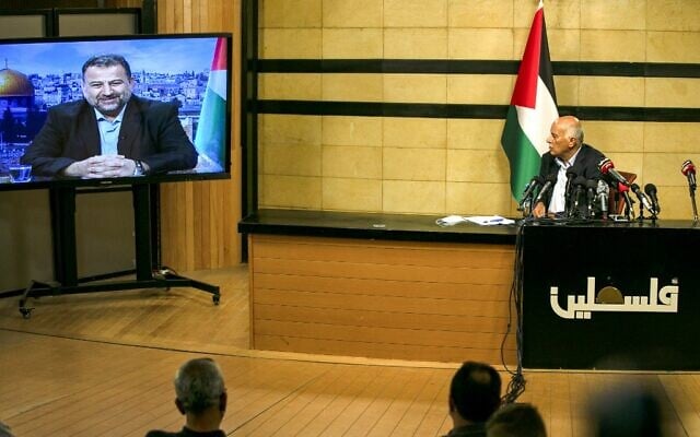 Senior Fatah official Jibril Rajoub, in the West Bank city of Ramallah, attends by video conference a meeting with deputy Hamas chief Saleh Arouri (on screen from Beirut) vowing joint resistance to Israel's plan to annex parts of the West Bank, on July 2, 2020. (ABBAS MOMANI / AFP) Senior Fatah official Jibril Rajoub, in the West Bank city of Ramallah, attends by video conference a meeting with deputy Hamas chief Saleh Arouri (on screen from Beirut) vowing joint resistance to Israel's plan to annex parts of the West Bank, on July 2, 2020. (ABBAS MOMANI / AFP)