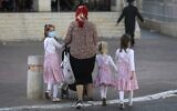 Ultra-Orthodox Jews walk in the West Bank Settlement of Beitar Illit on July 8, 2020 (MENAHEM KAHANA / AFP)