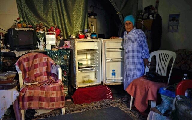 In this file photo taken on June 17, 2020, a Lebanese woman stands next to her empty refrigerator in her apartment in the port city of Tripoli north of the capital Beirut (IBRAHIM CHALHOUB / AFP) In this file photo taken on June 17, 2020, a Lebanese woman stands next to her empty refrigerator in her apartment in the port city of Tripoli north of the capital Beirut (IBRAHIM CHALHOUB / AFP)