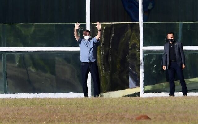 Brazilian President Jair Bolsonaro waves outside Alvorada Palace in Brasilia on July 9, 2020. (Photo by EVARISTO SA / AFP) Brazilian President Jair Bolsonaro waves outside Alvorada Palace in Brasilia on July 9, 2020. (Photo by EVARISTO SA / AFP)
