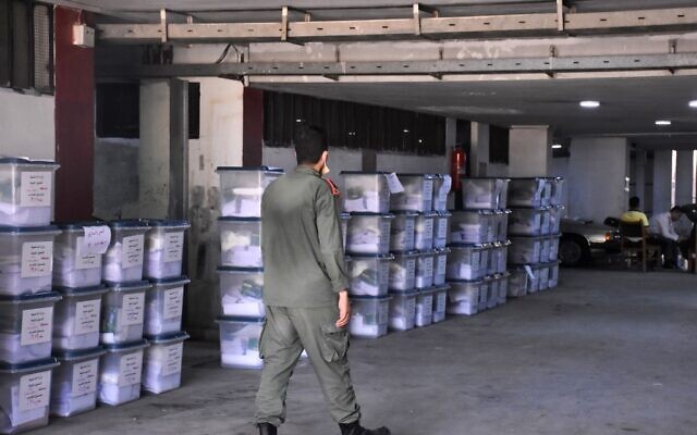 A Syrian policeman walks past ballot boxes, ahead of handing them over to the police to deliver them to polling stations on the eve of the parliamentary elections, in the Syrian city of Aleppo on July 18, 2020 (AFP) A Syrian policeman walks past ballot boxes, ahead of handing them over to the police to deliver them to polling stations on the eve of the parliamentary elections, in the Syrian city of Aleppo on July 18, 2020 (AFP)