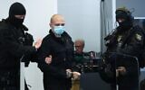 Stephan Balliet, who is accused of shooting dead two people after an attempt to storm a synagogue in Halle, arrives at the district court in Magdeburg, eastern Germany on July 21, 2020. (Ronny Hartmann/various sources/AFP)