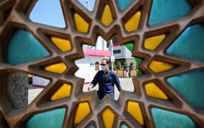 An Iranian man, wearing a protective face mask, walks down a street in the capital Tehran on July 22, 2020. (ATTA KENARE/AFP)