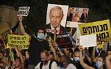Israeli protesters hold placards during a demonstration against Prime Minister Benjamin Netanyahu in Jerusalem, on July 23, 2020. (Ahmad GHARABLI / AFP)