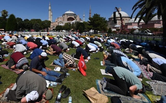 Men take part in the Friday prayer on July 24, 2020 outside Hagia Sophia in Istanbul, the first Muslim prayer held at the landmark since it was reconverted to a mosque despite international condemnation. (OZAN KOSE / AFP)