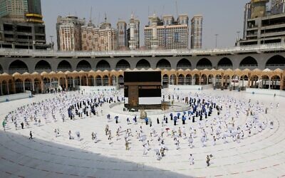 Pilgrims circumambulating around the Kaaba, Islam's holiest shrine, at the centre of the Grand Mosque in the holy city of Mecca, at the start of the annual Muslim Hajj pilgrimage, July 29, 2020. (STR / AFP)