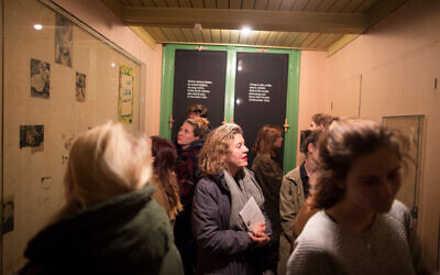 Visitors study the room that used to be Anne Frank's at the museum devoted to her memory in Amsterdam, November 24, 2016. (Photo Collection Anne Frank House/ via JTA)