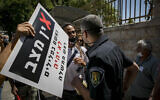 Jerusalem municipality inspector speaks to a demonstrator near Prime Minister Benjamin Netanyahu's official residence in Jerusalem on July 13 2020 (Olivier Fitoussi/Flash90)
