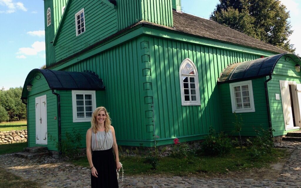 Holly Huffnagle stands in front of a Tatar mosque in Kruszyniany while researching Jewish-Muslim relations in interwar Poland, 2013. (Courtesy)