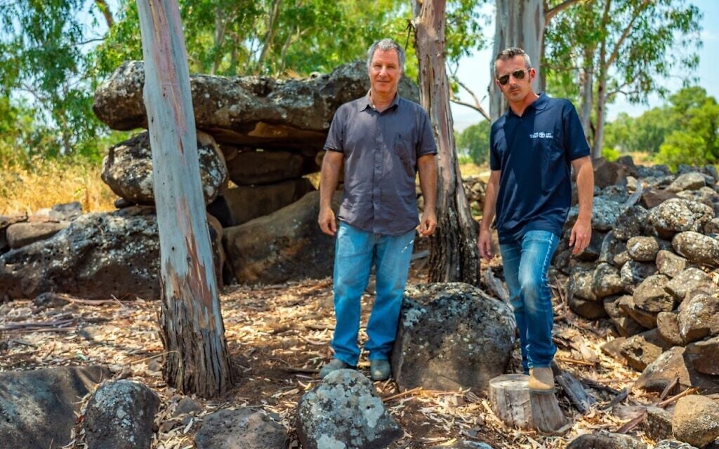 Researchers Prof. Gonen Sharon of Tel-Hai College (left) and Uri Berger of the Israel Antiquities Authority, with the dolmen discovered in the Yehudiya Nature Reserve. (Yaniv Berman, Israel Antiquities Authority)