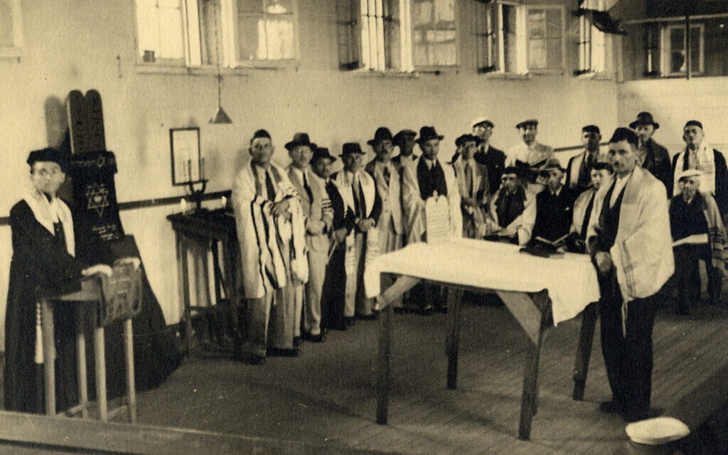 A group of men praying at one of the synagogues set up in the prison in Beau Bassin (Courtesy Ghetto Fighters’ House Archives, Israel)