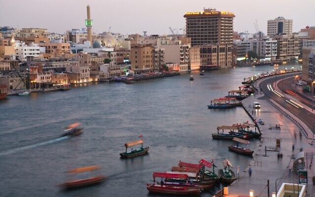 In this photograph taken with a slow shutter speed, traditional abra boats navigate the Dubai Creek in Dubai, United Arab Emirates on July 1, 2020. (AP Photo/Jon Gambrell) In this photograph taken with a slow shutter speed, traditional abra boats navigate the Dubai Creek in Dubai, United Arab Emirates on July 1, 2020. (AP Photo/Jon Gambrell)