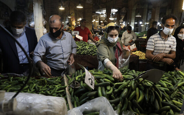People wearing face masks to help prevent the spread of the coronavirus shop at the old grand bazaar of the Iranian city of Zanjan on July 5, 2020. (AP/Vahid Salemi) People wearing face masks to help prevent the spread of the coronavirus shop at the old grand bazaar of the Iranian city of Zanjan on July 5, 2020. (AP/Vahid Salemi)