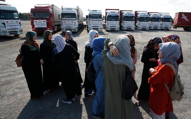 In this September 10, 2018 file photo, members of a Turkish pro-government aid group, wait for the departure of trucks carrying humanitarian aid destined for Idlib, Syria, in Istanbul. (AP Photo/Lefteris Pitarakis) In this September 10, 2018 file photo, members of a Turkish pro-government aid group, wait for the departure of trucks carrying humanitarian aid destined for Idlib, Syria, in Istanbul. (AP Photo/Lefteris Pitarakis)