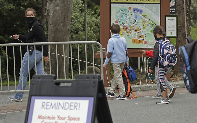 A class keeps social distance at the San Francisco Zoo on Monday, July 13, 2020, in San Francisco. (AP Photo/Ben Margot) A class keeps social distance at the San Francisco Zoo on Monday, July 13, 2020, in San Francisco. (AP Photo/Ben Margot)