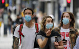 Shoppers wearing protective face masks walk along Oxford Street in London, July 14, 2020. (AP Photo/Frank Augstein)