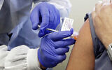 A subject receives a shot in the first-stage safety study clinical trial of a potential vaccine by Moderna for COVID-19, the disease caused by the new coronavirus, at the Kaiser Permanente Washington Health Research Institute in Seattle, March 16, 2020. (AP/Ted S. Warren, File)